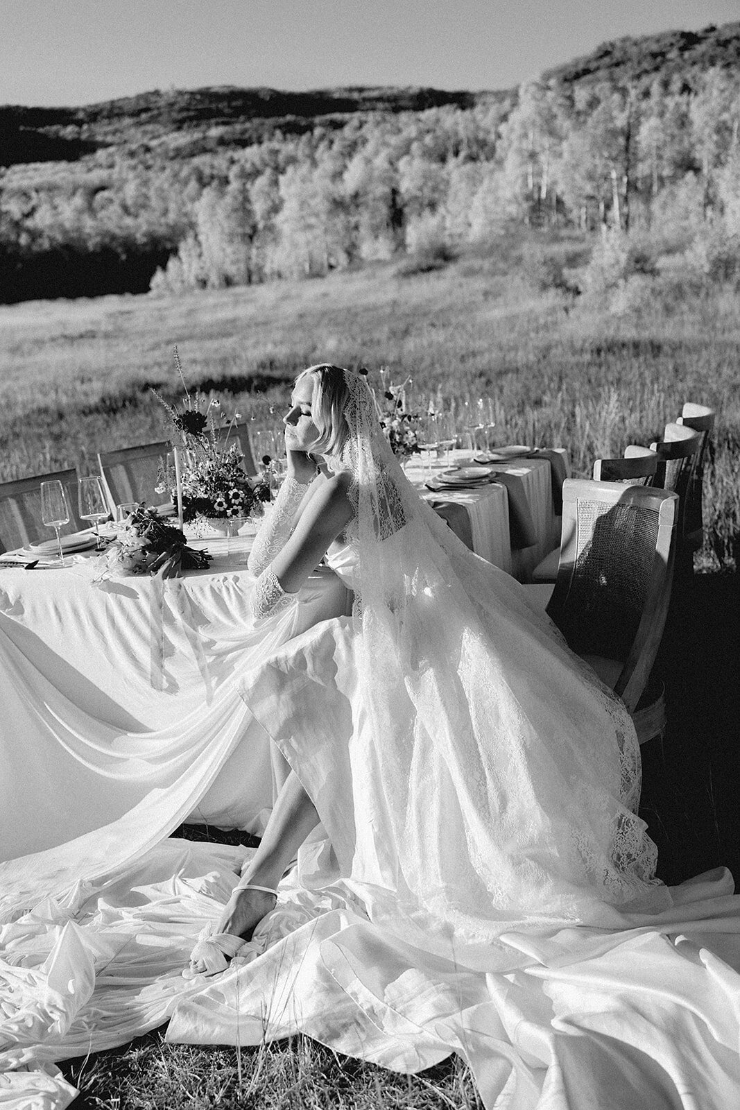 Editorial style photograph of a bride sitting at a table with beautiful lighting in park city.