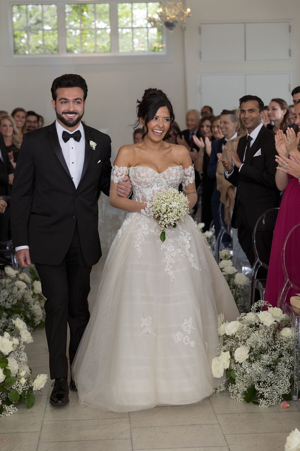 Bride walks down the aisle during indoor wedding ceremony at Belle Mer, Newport.