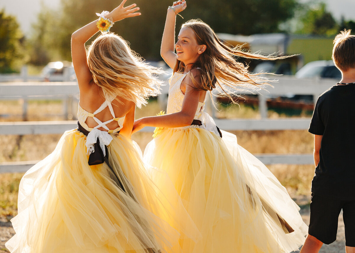 Flower girls dancing during wedding reception at private property wedding in Stevensville, MT