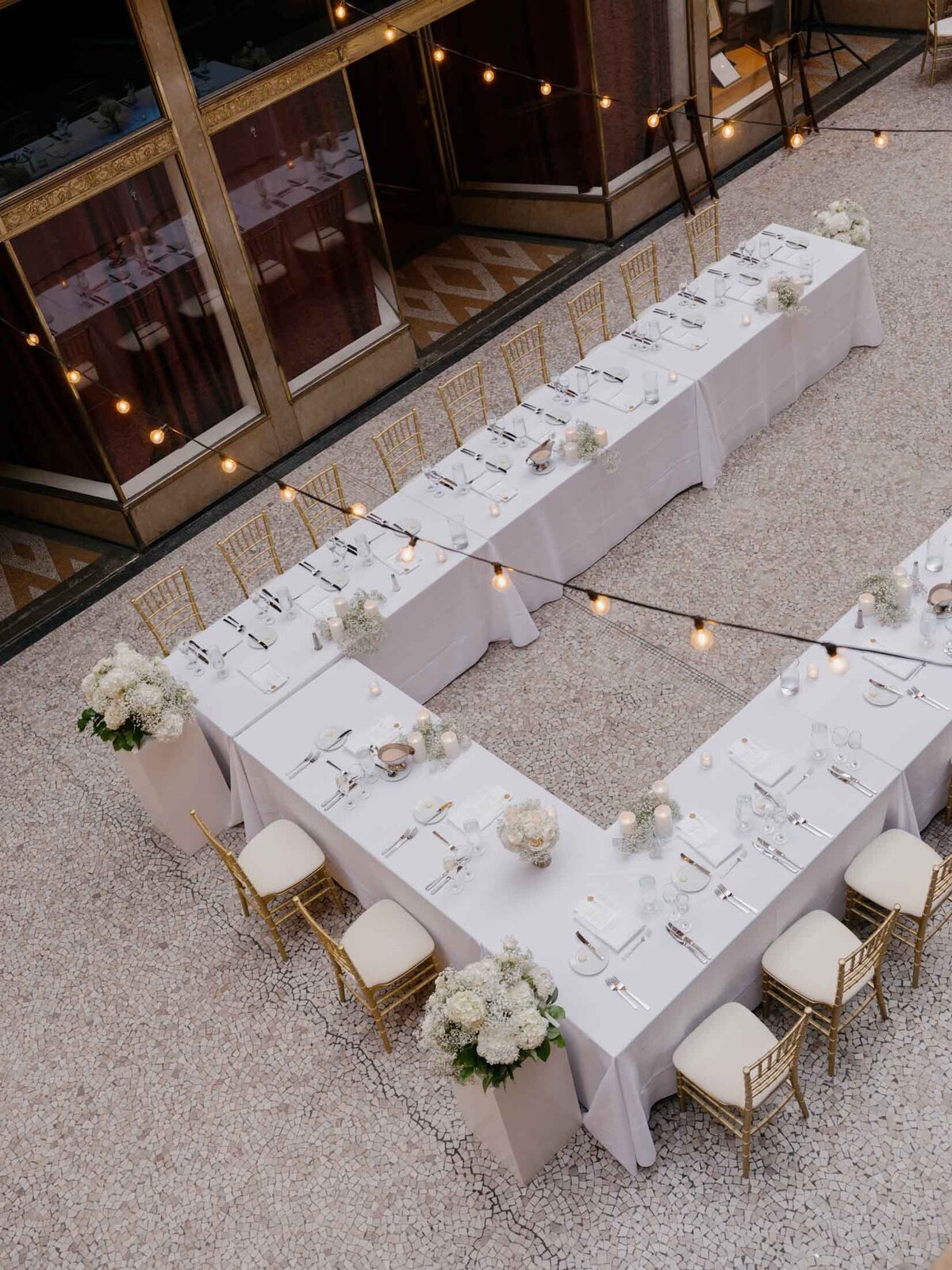 Overhead view of reception at The Arcade with string lights and modern decor