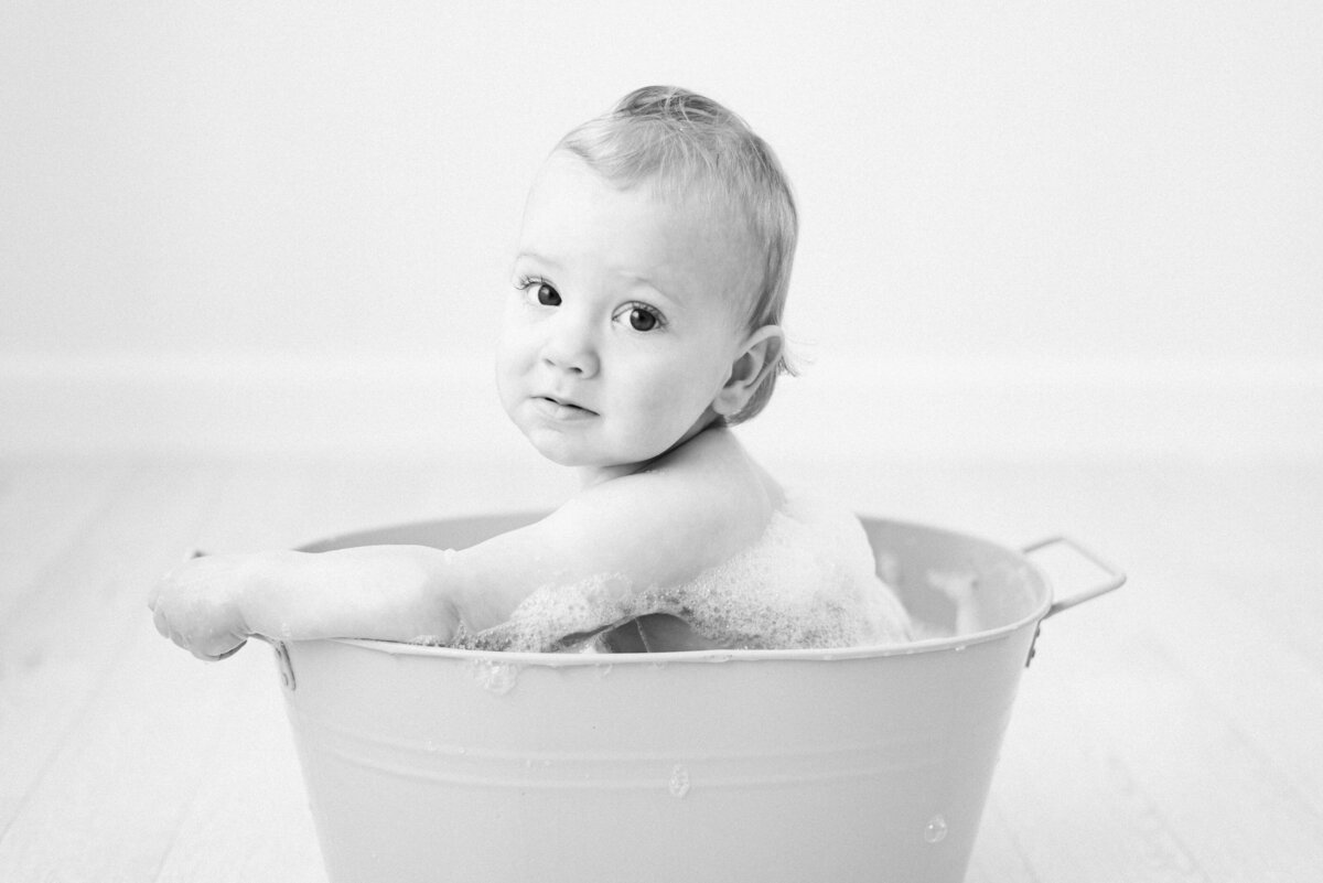 Baby in a bath on west sussex cake smash photoshoot