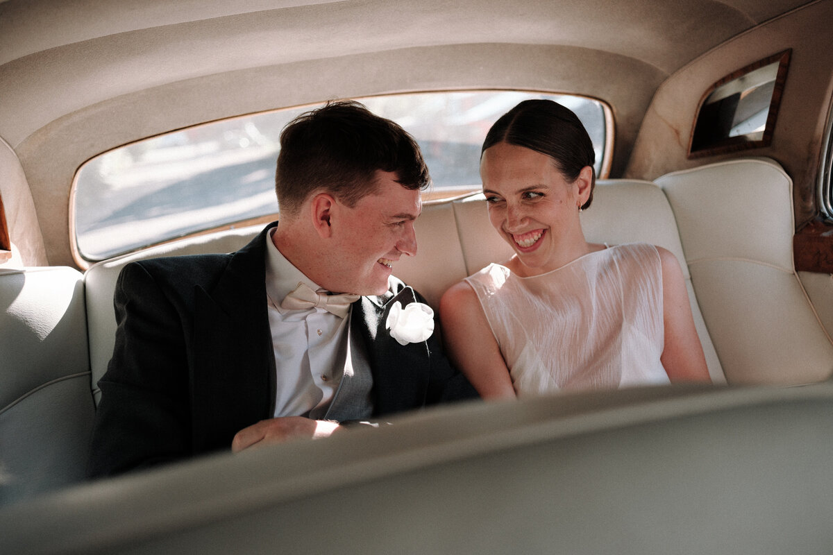 back of vintage car with newlyweds