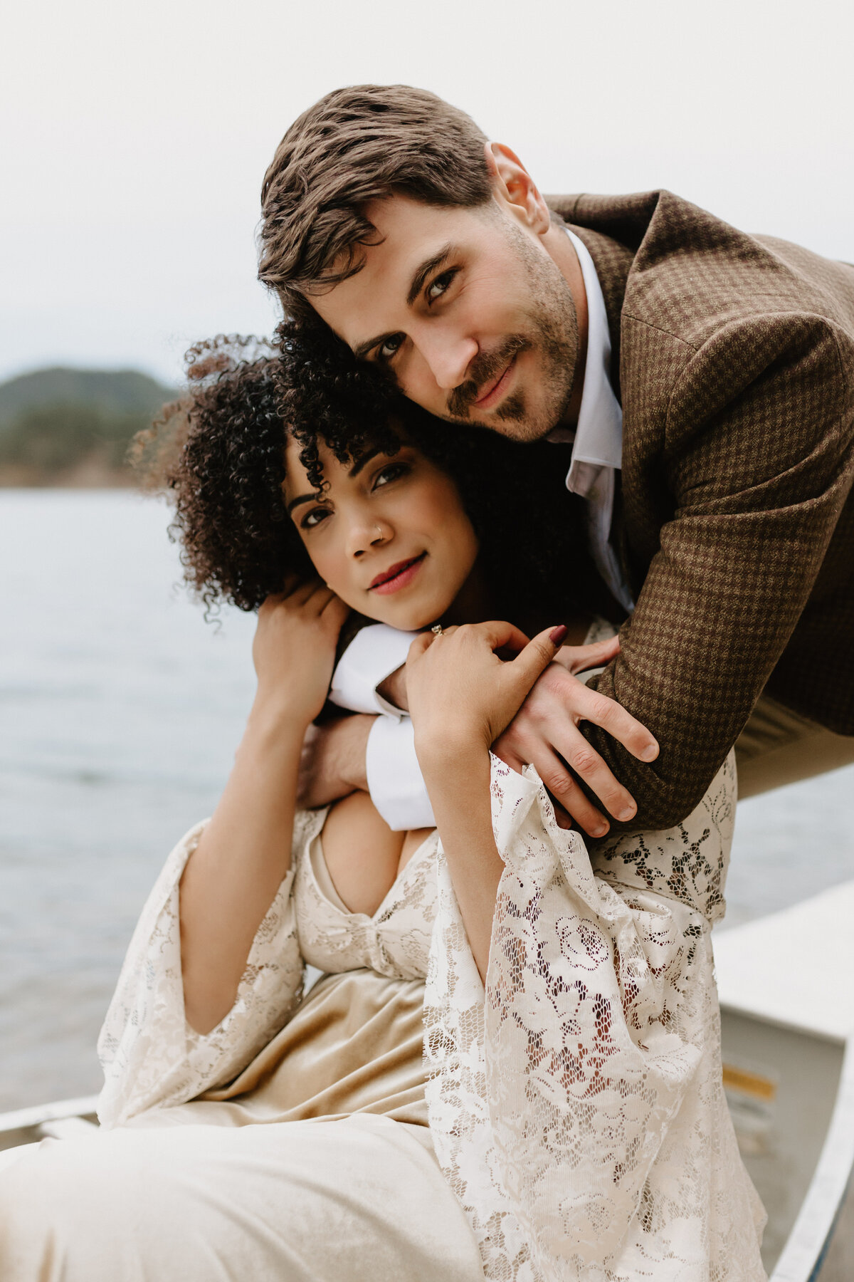 lakeside elopement with couple kissing in front of lake and canoe mariah jones photography