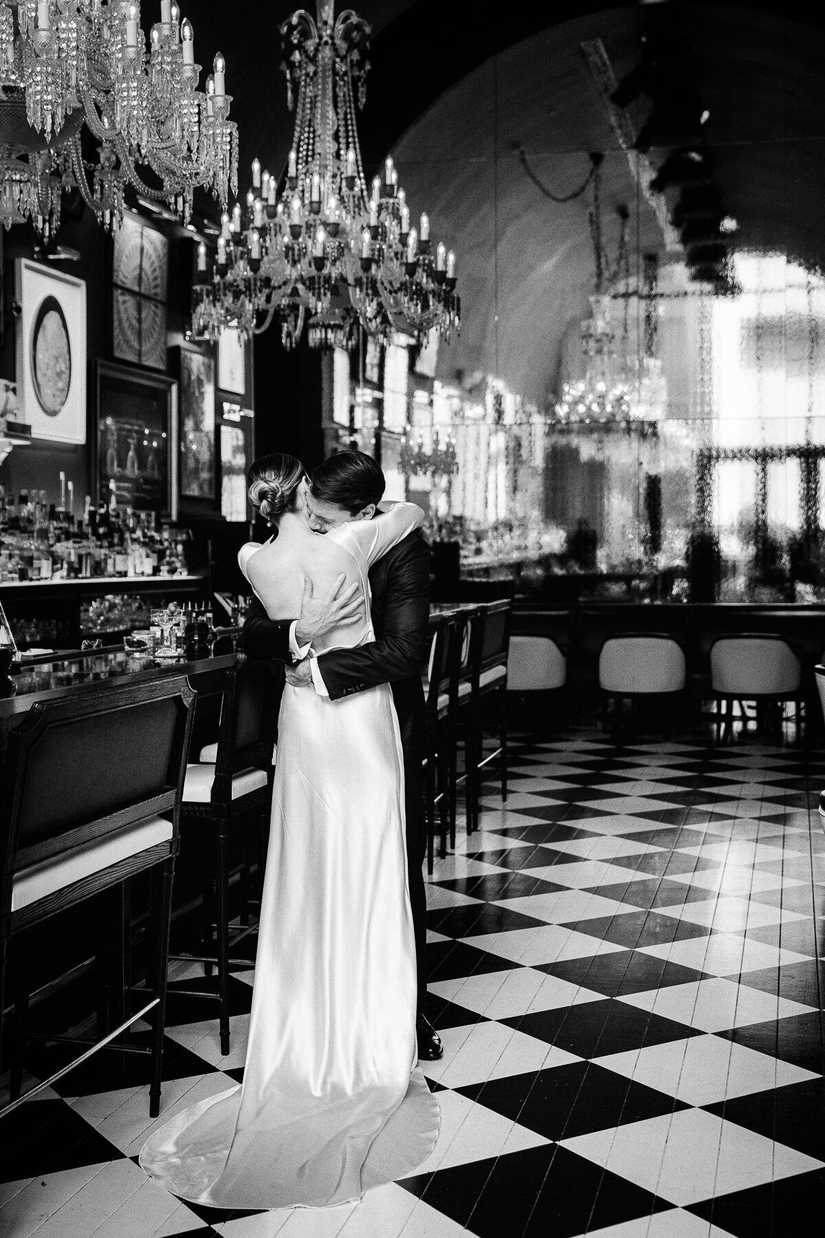 A couple embrace in the bar of  the Baccarat Hotel