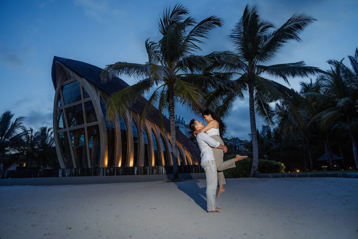 Bali Indonesia Elopement Asian Bride and Groom at Apurva Kempinski beach at night lifting.