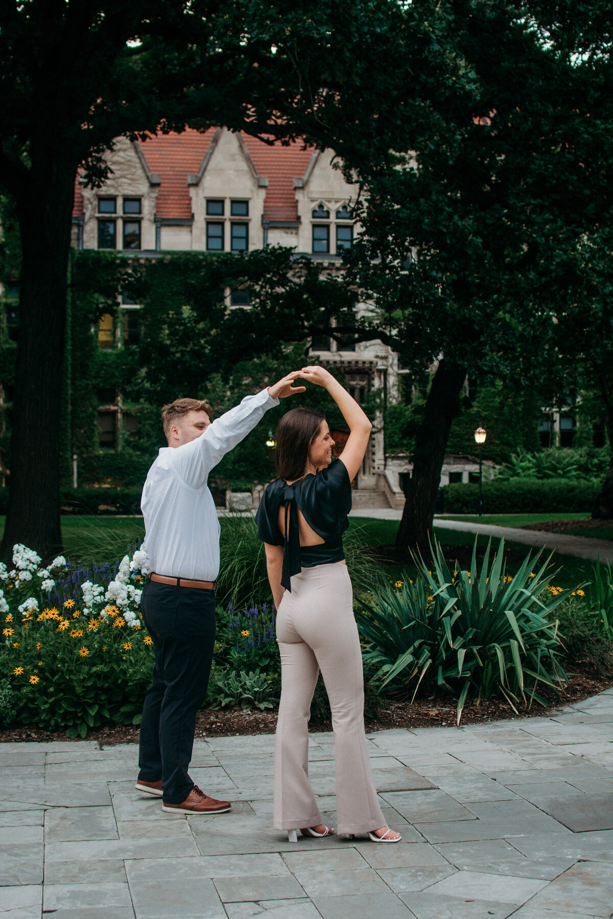 Dancing couple during their engagement photo session at the campus of Chicago University