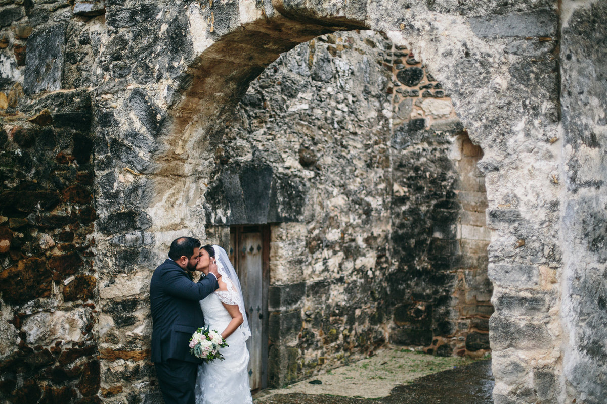 Married couple posing for San Antonio Wedding Photographer at Mission San Juan Capistrano wedding venue by Expose the Heart