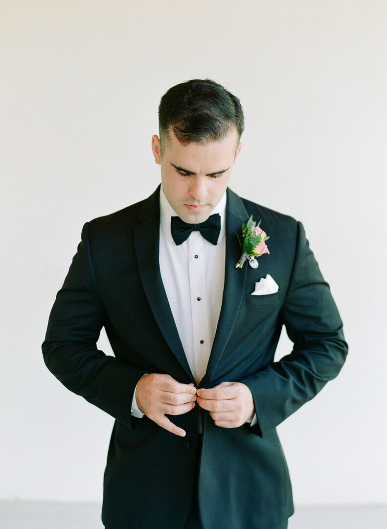 Groom Buttoning Jacket Photo