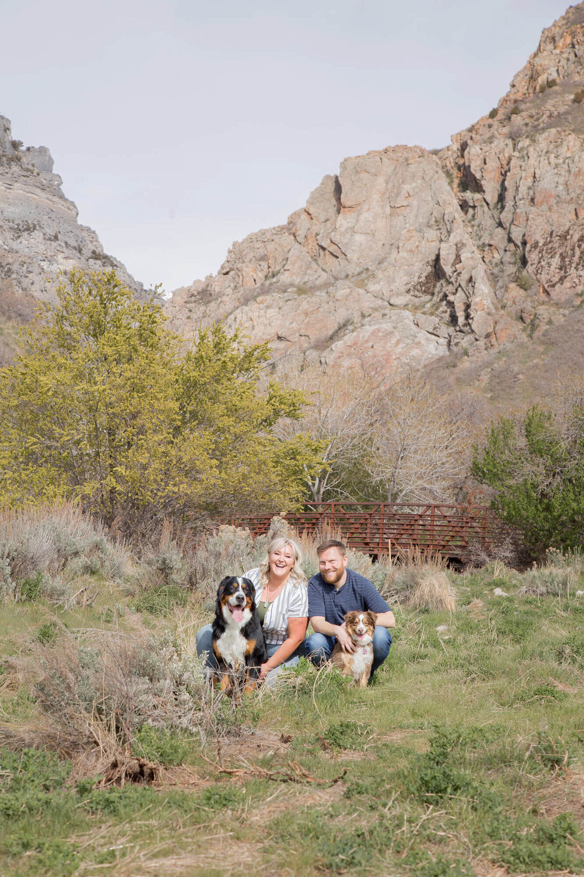 Couple with two dogs in mountain park