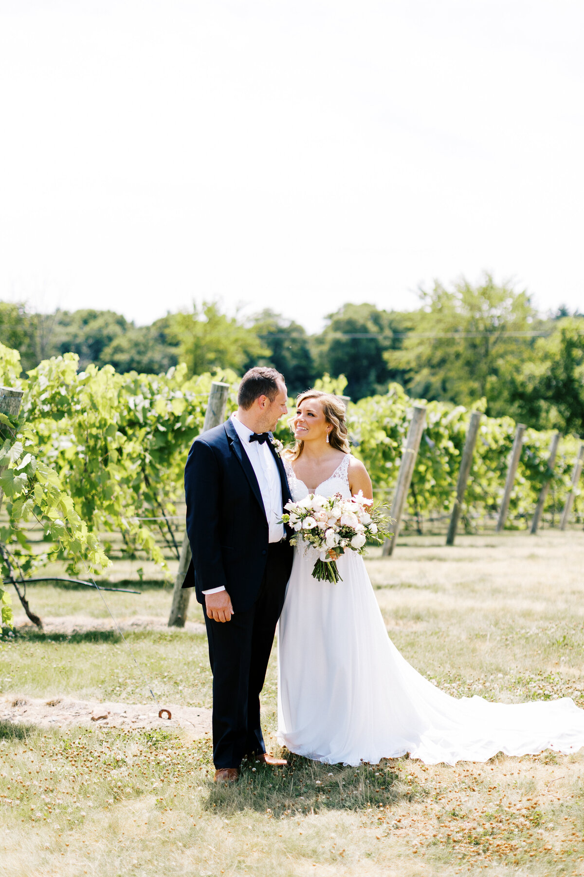 newlyweds at the vineyard happily looking at each other