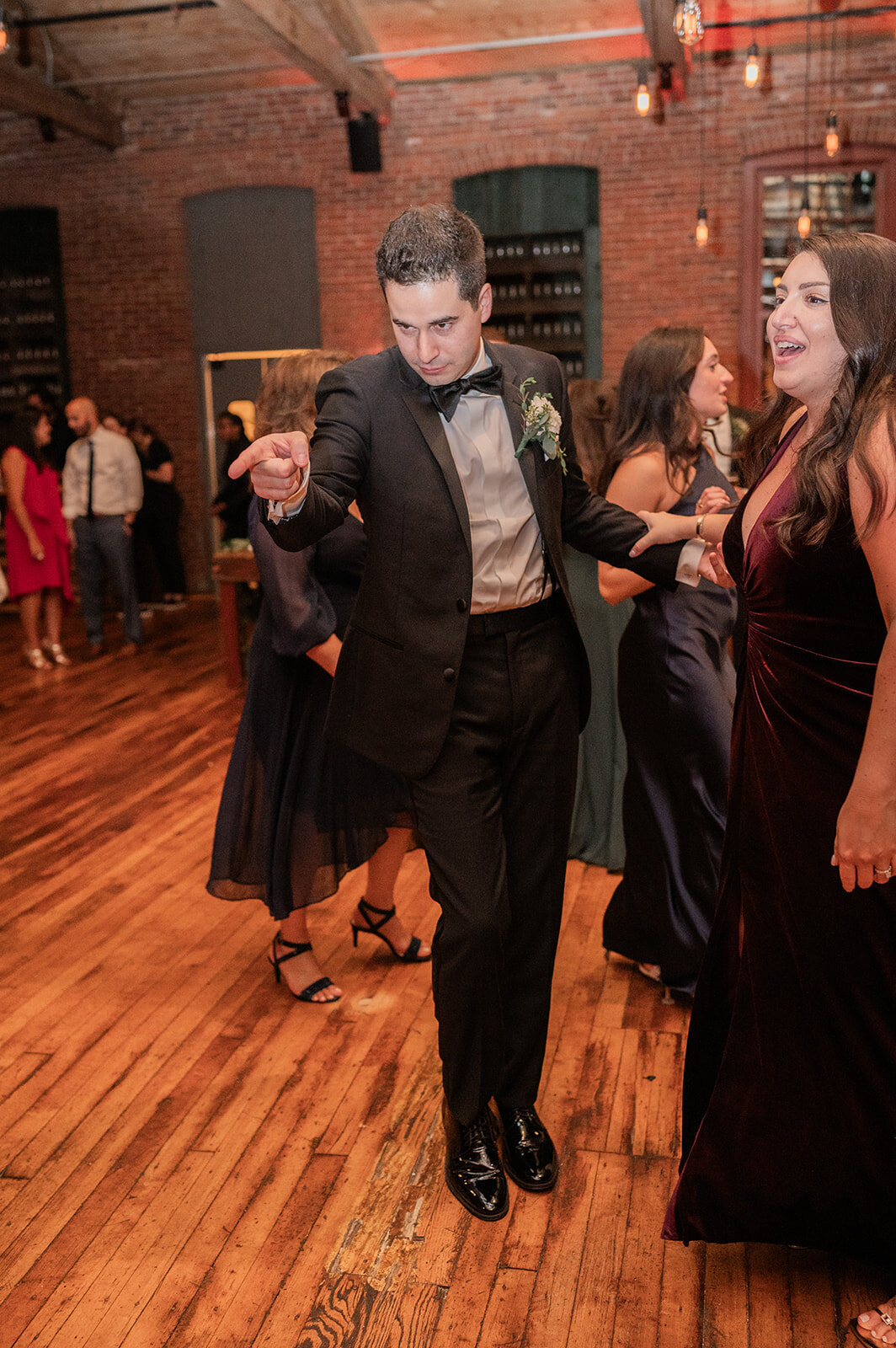 groom gets playful while dancing at his wedding reception