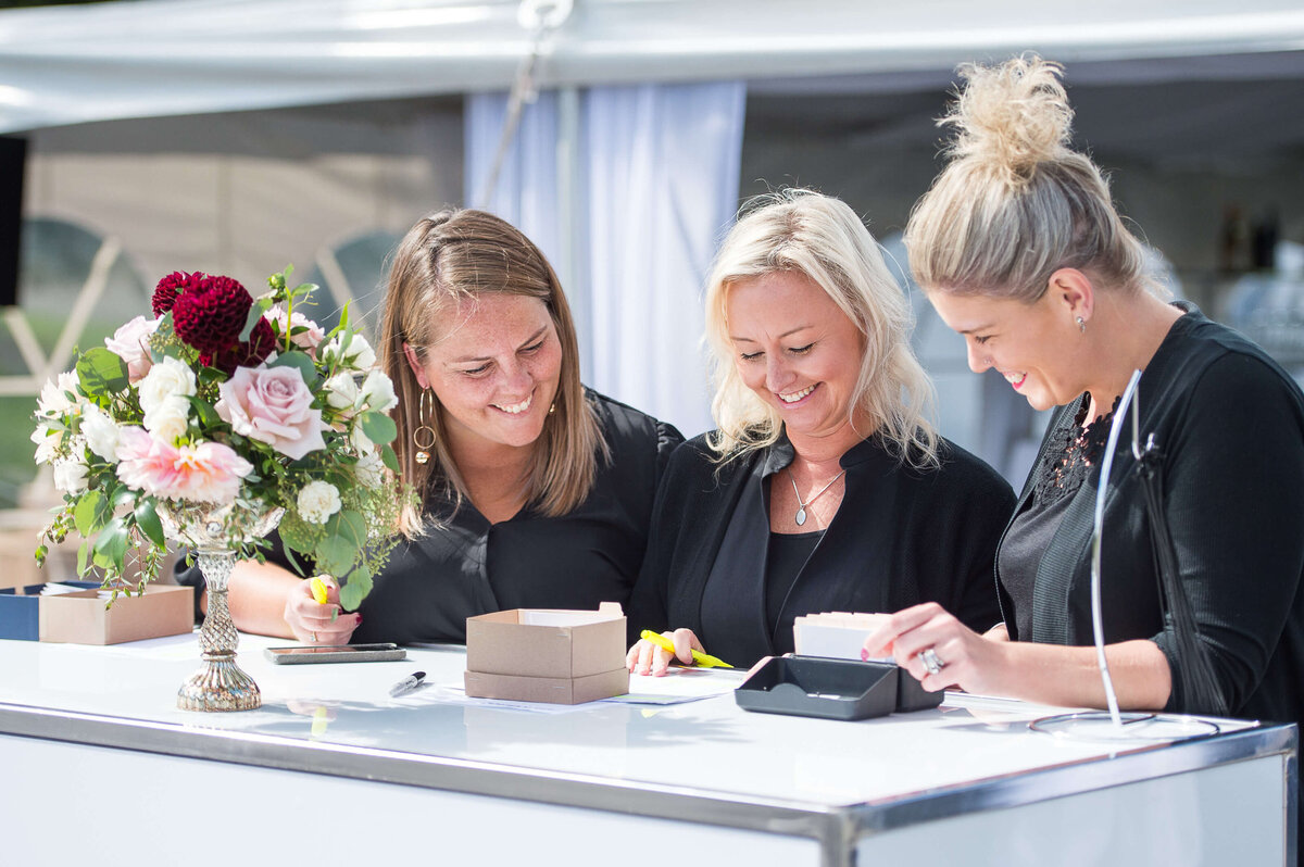Ottawa event photography showing a registration team greeting guests during a corporate anniversary celebration.  Captured by JEMMAN Photography COMMERCIAL