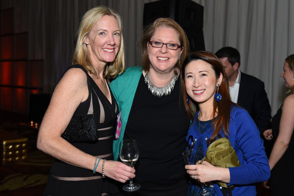 Professionals posing for a group photo during a corporate celebration in Toronto, captured in a formal setting