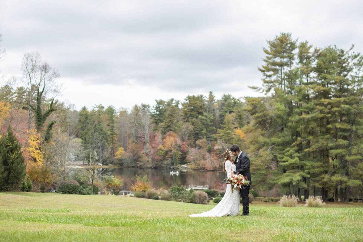 Couple kissing fall wedding Highland Lake Inn Hendersonville, NC