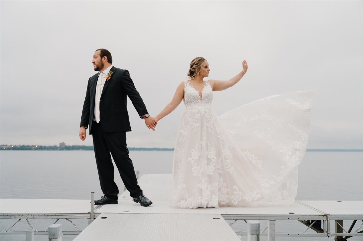 Bride and groom on dock during evening sunset portraits