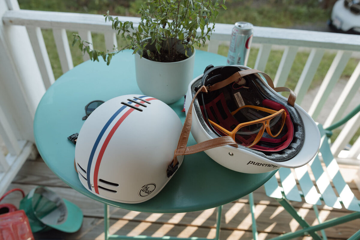 Motorcycle helmets and sunglasses on a small outdoor table