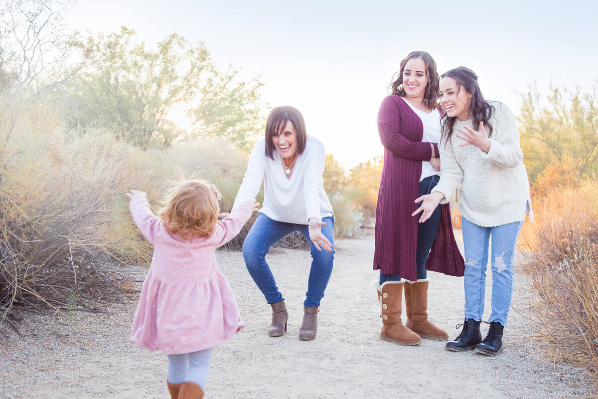 redheaded toddler running into grandma's arms in desert park