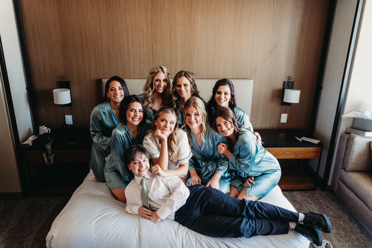 Bridal party sits together at Hilton Downtown Cleveland Hotel