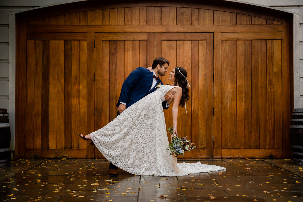 A bride and groom dip at Saltwater Farm Vineyard In Stonington Connecticut.
