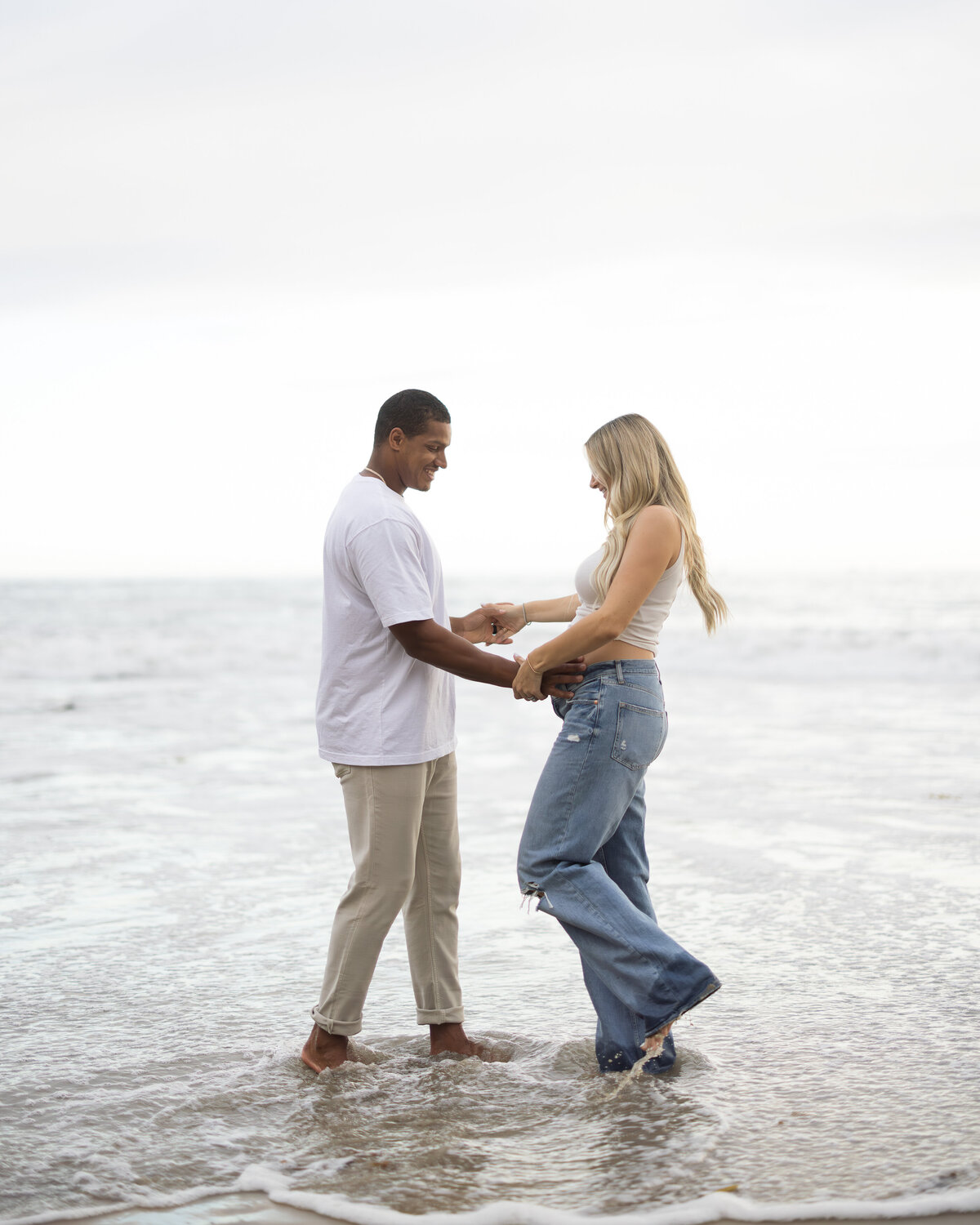 candid maternity photo at the beach