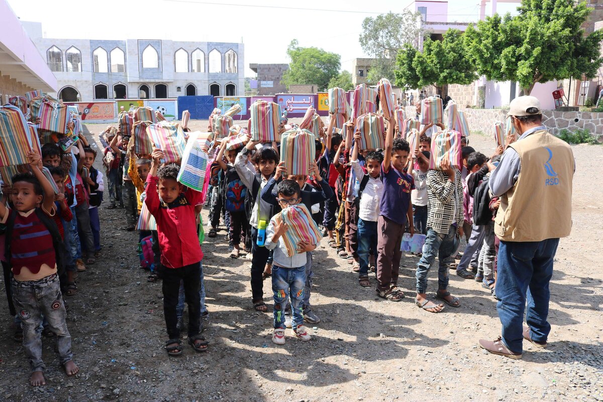 Student receiving_school supplies in Yard