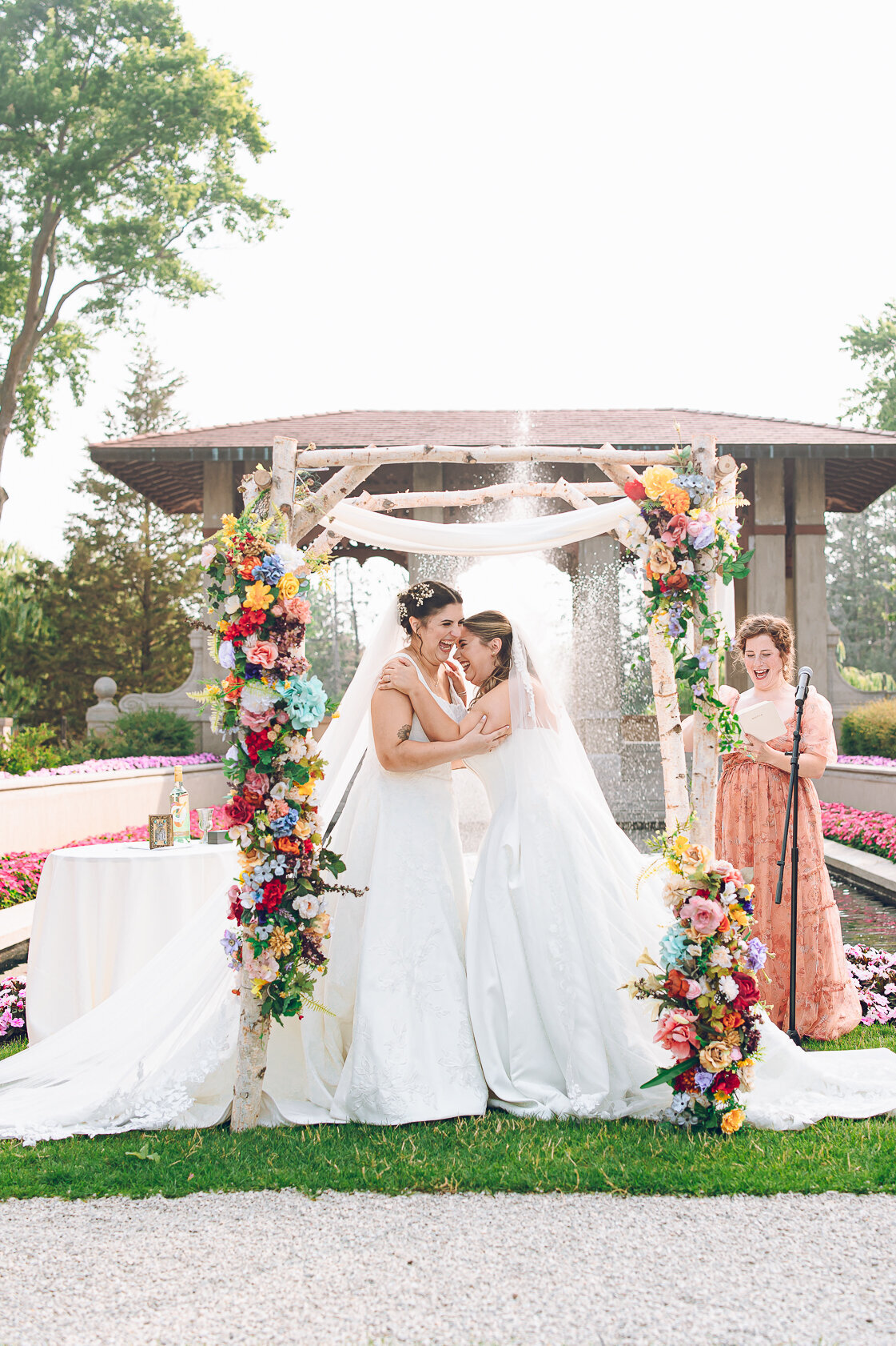 A queer couple breaks glasses during their Jewish ceremony at Armour House in Lake Forest