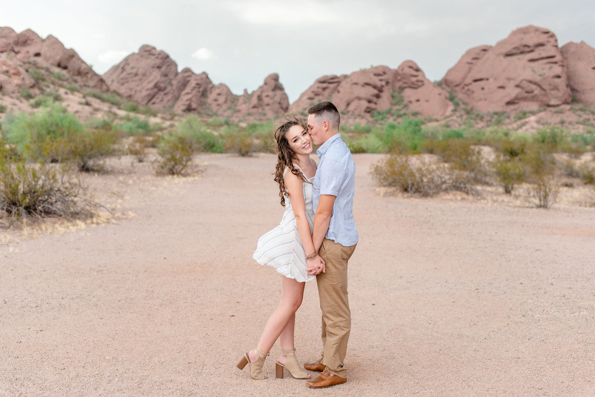 couple holds hands at papago park