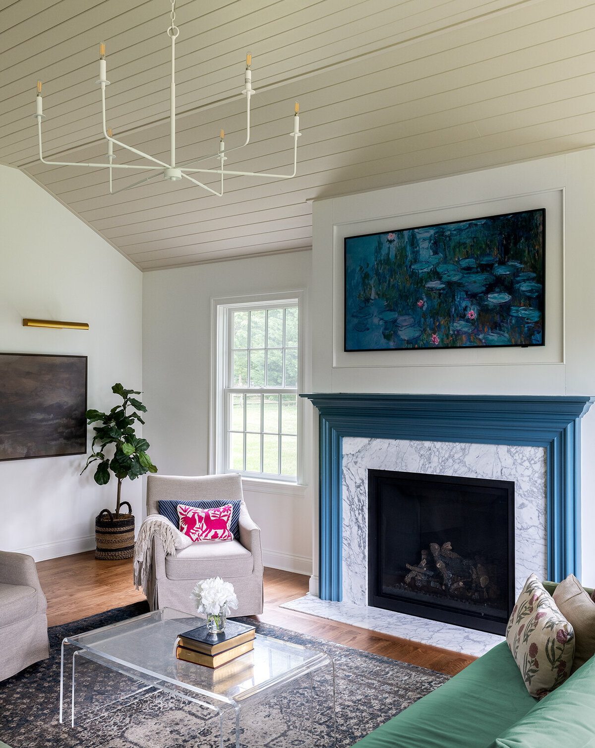 white living room with high celing and blue green fireplace accent wall