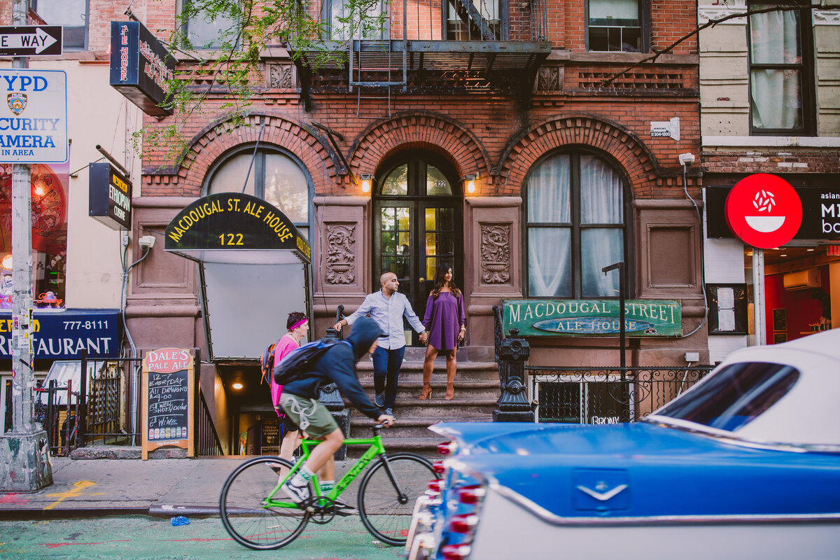 A couple standing on stoop steps on macdougal street in the village nyc