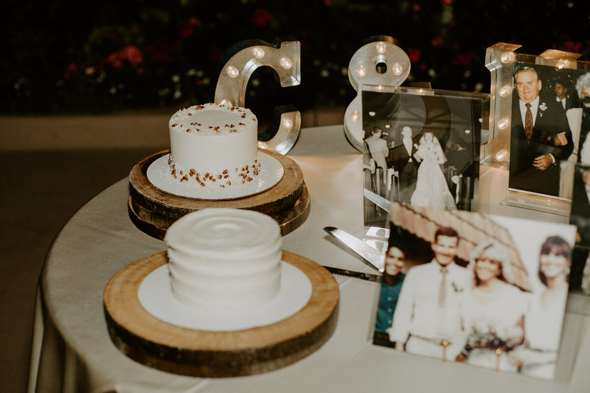 White cutting cakes at wedding reception.