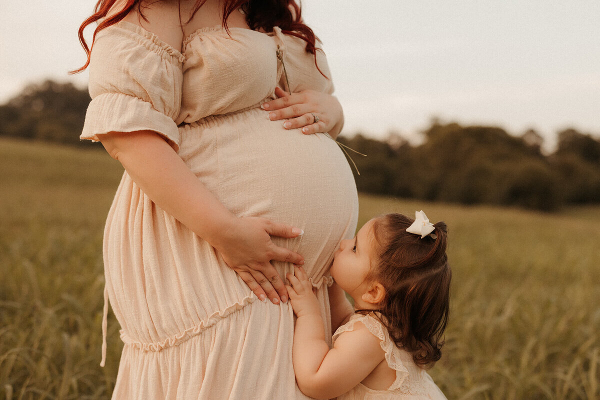 Pregnant woman posing in neutral gown during Franklin Tennessee studio maternity shoot