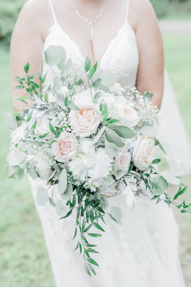 light and bright bridal bouquet with roses and eucalyptus.