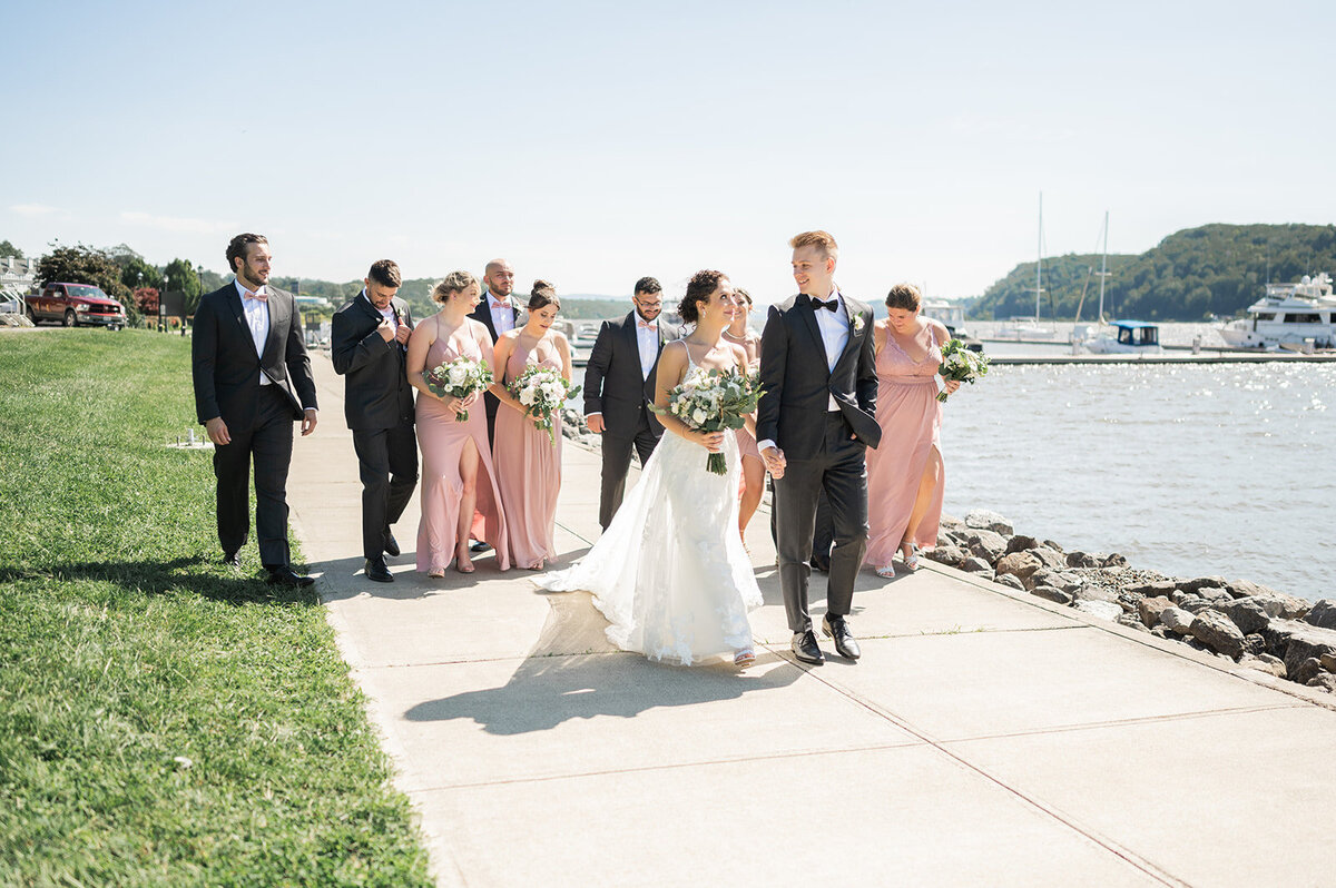 bridal party stroll along waterfront during grandview wedding