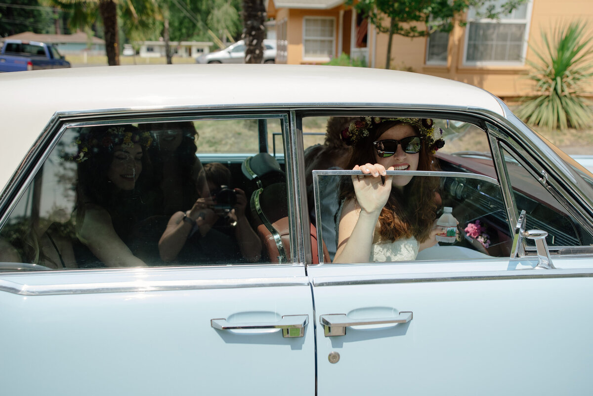 bride-sunglasses-peeking-out-vintage-car-window