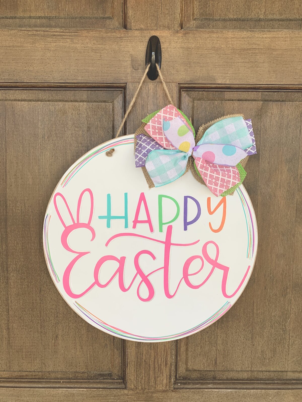 Happy Easter hand lettered in pink and multicolors on white background