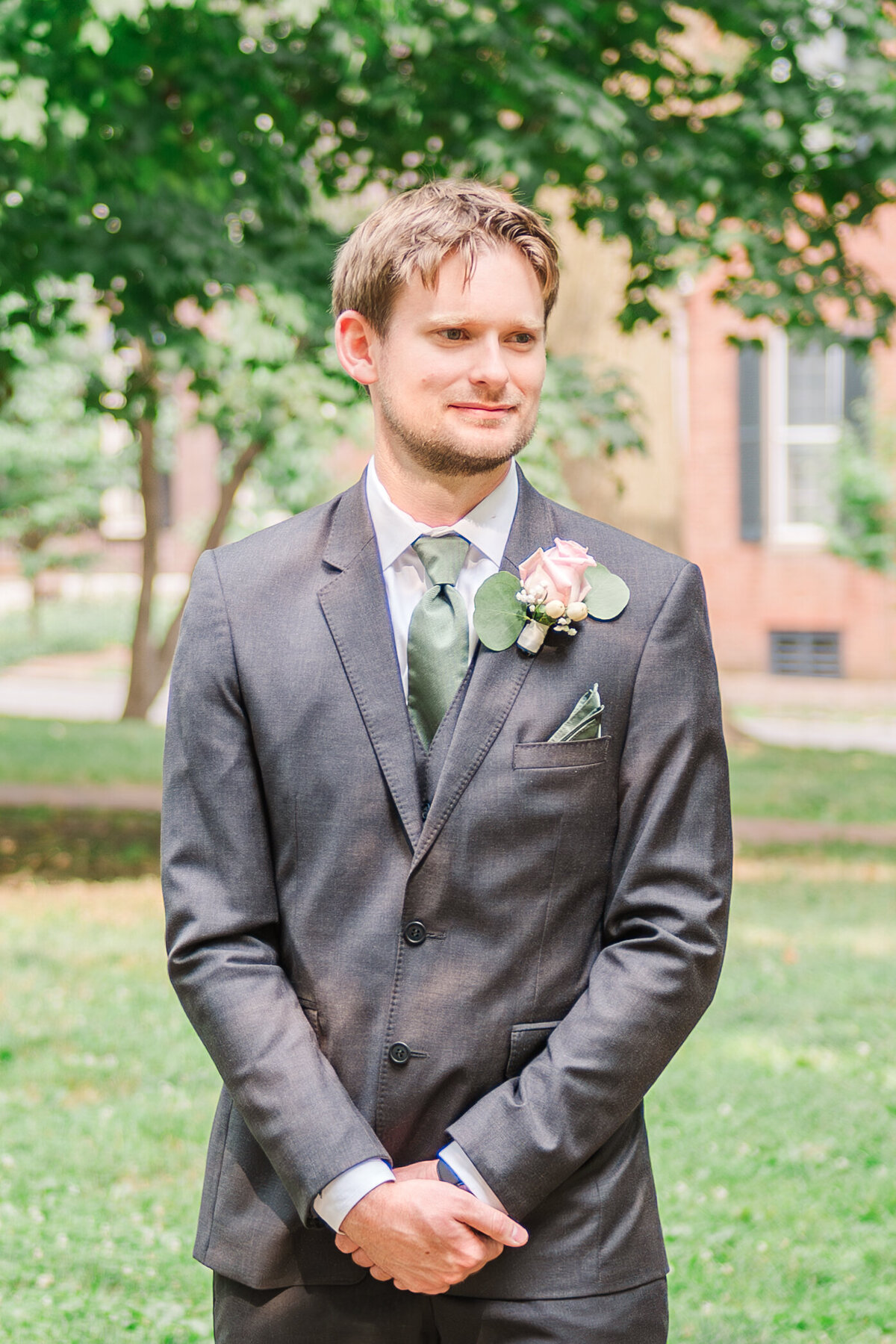 groom watching his bride come down the aisle at the altar