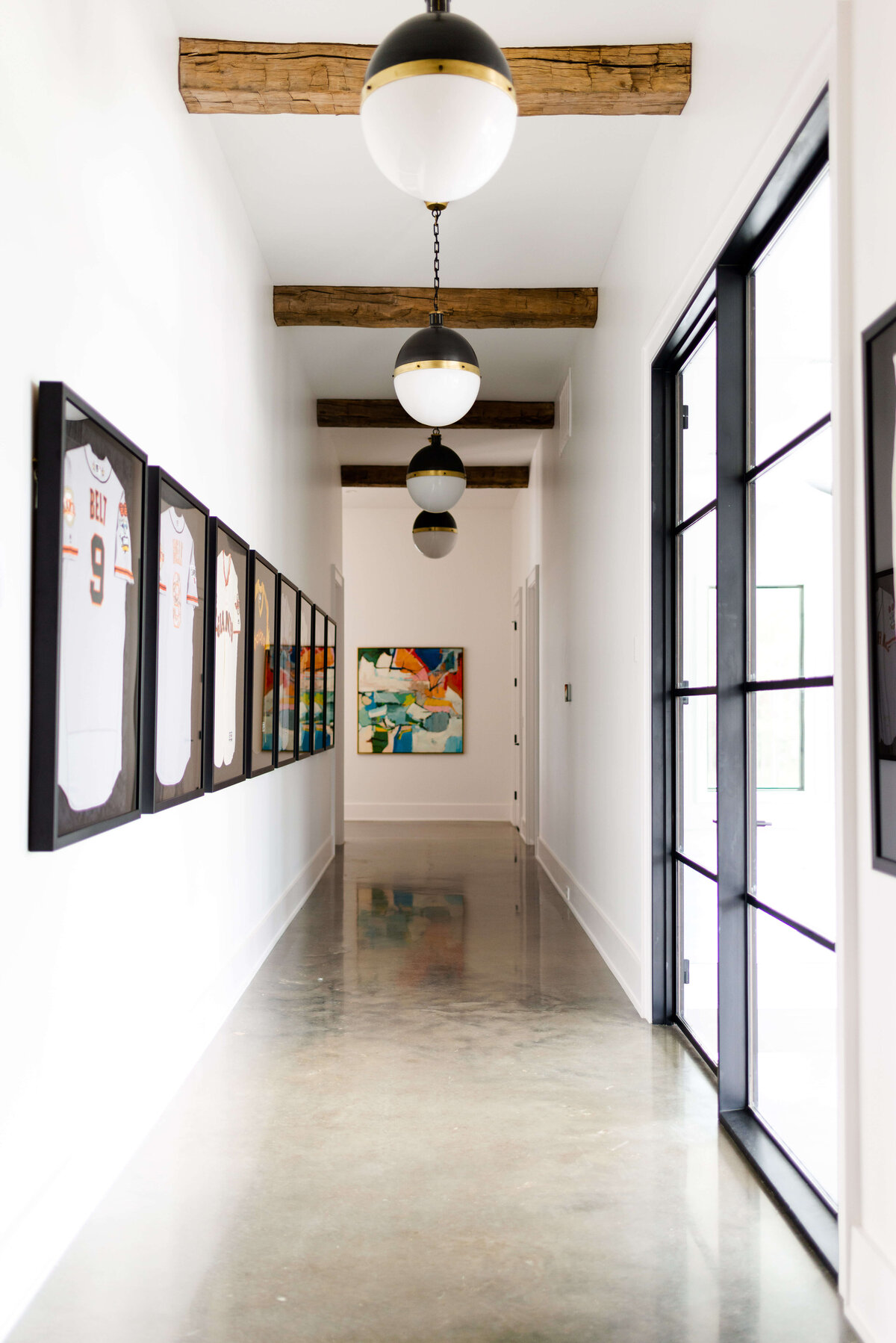 oyster creek studios building belt new build hallway with accent lighting and artwork