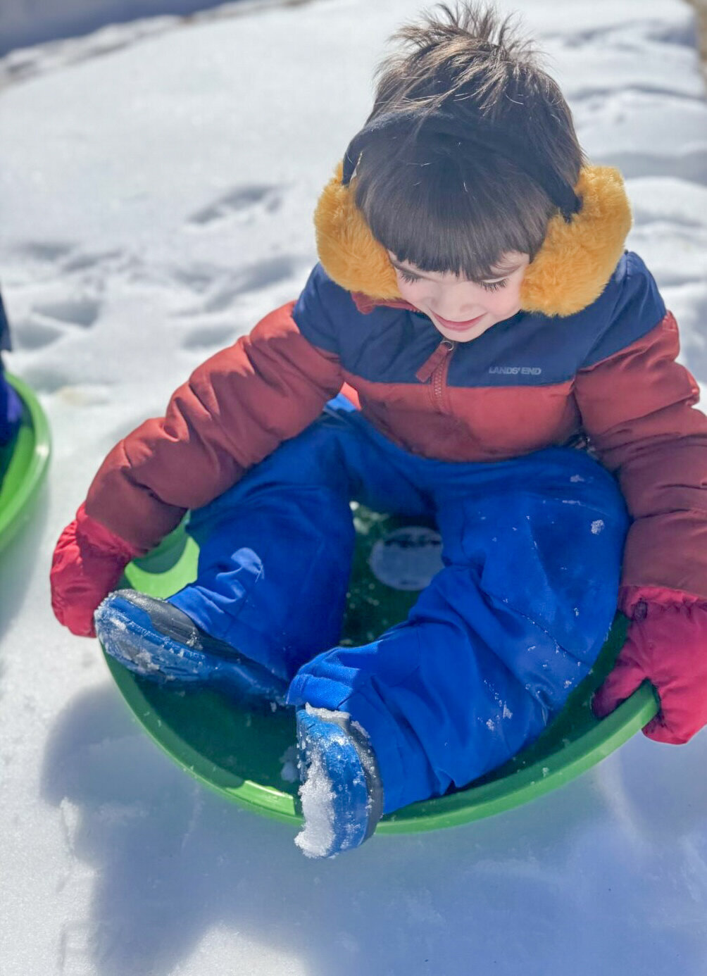 Student playing on the sled in the snow at House of Parker Preschool where we believe that play isn’t just something children do—it’s how they learn. Through play, children discover the world around them, express their creativity, build relationships, and develop the foundational skills they’ll carry with them for life.