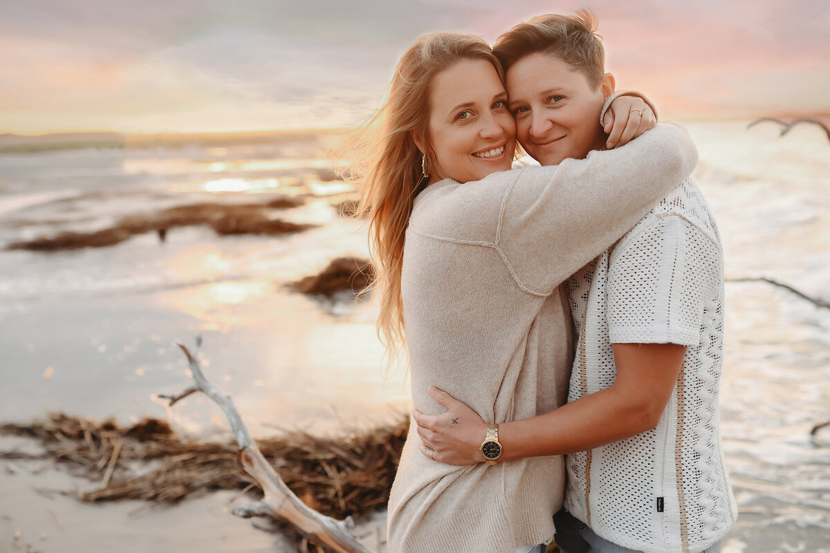 LGBTQ Friendly Photographer in Charleston, South Carolina. Same Sex couple embraces for portraits on Folly Beach.