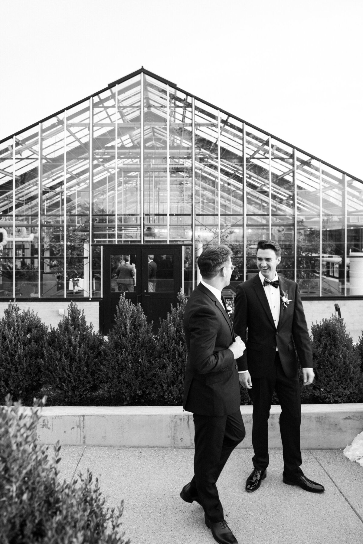 groom and best man outside a greenhouse wedding reception