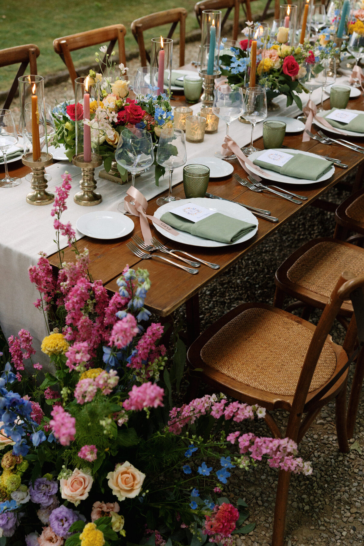 Candlelit reception table with floral centerpieces and warm tones