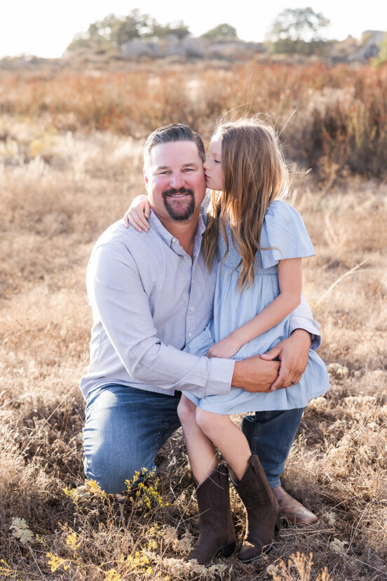 daughter-kissing-father-wrights-field-san-diego