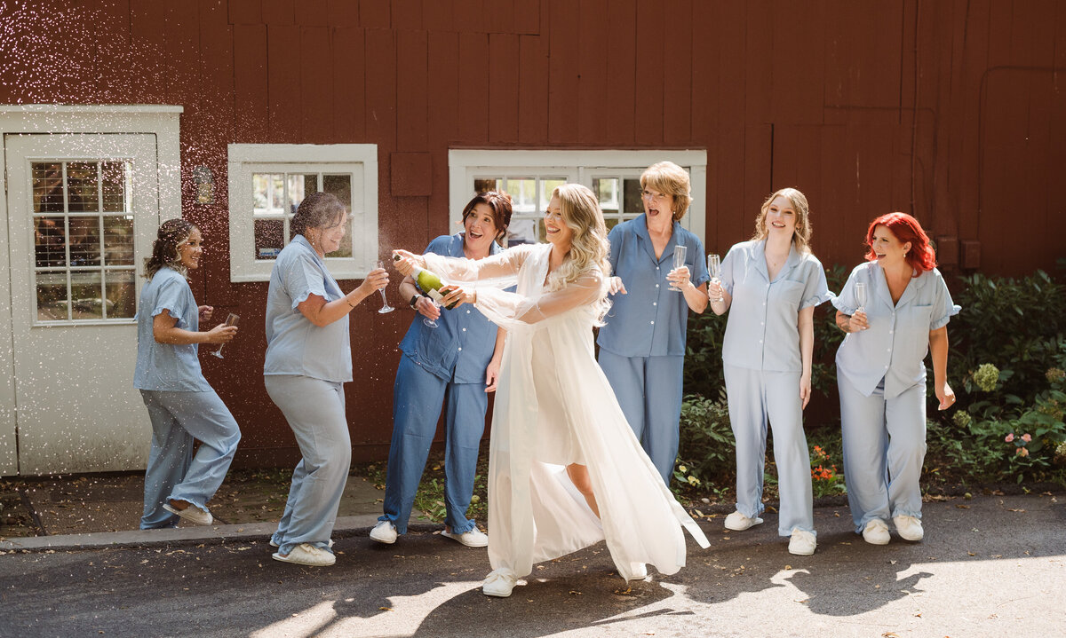 popping champagne outside the bridal suite at the inn at millrace pond nj