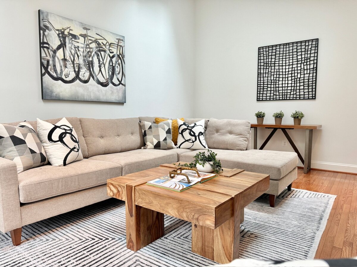 Living space with couch, coffee table, and abstract art
