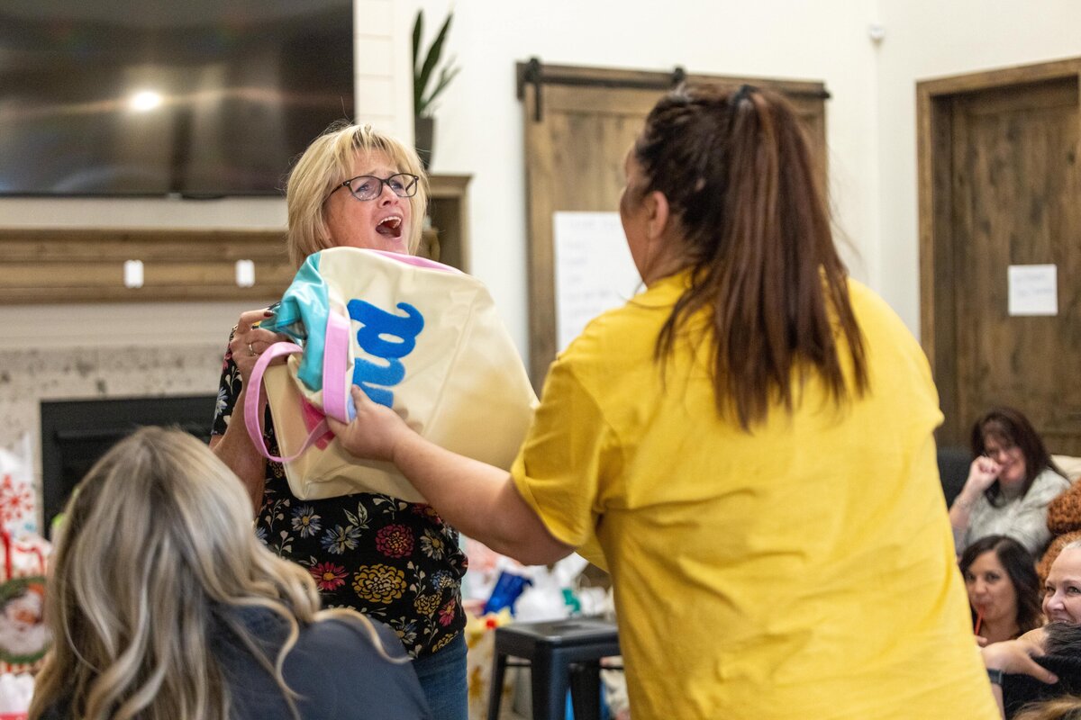 woman giving an appreciative face to another woman who gave her a gift