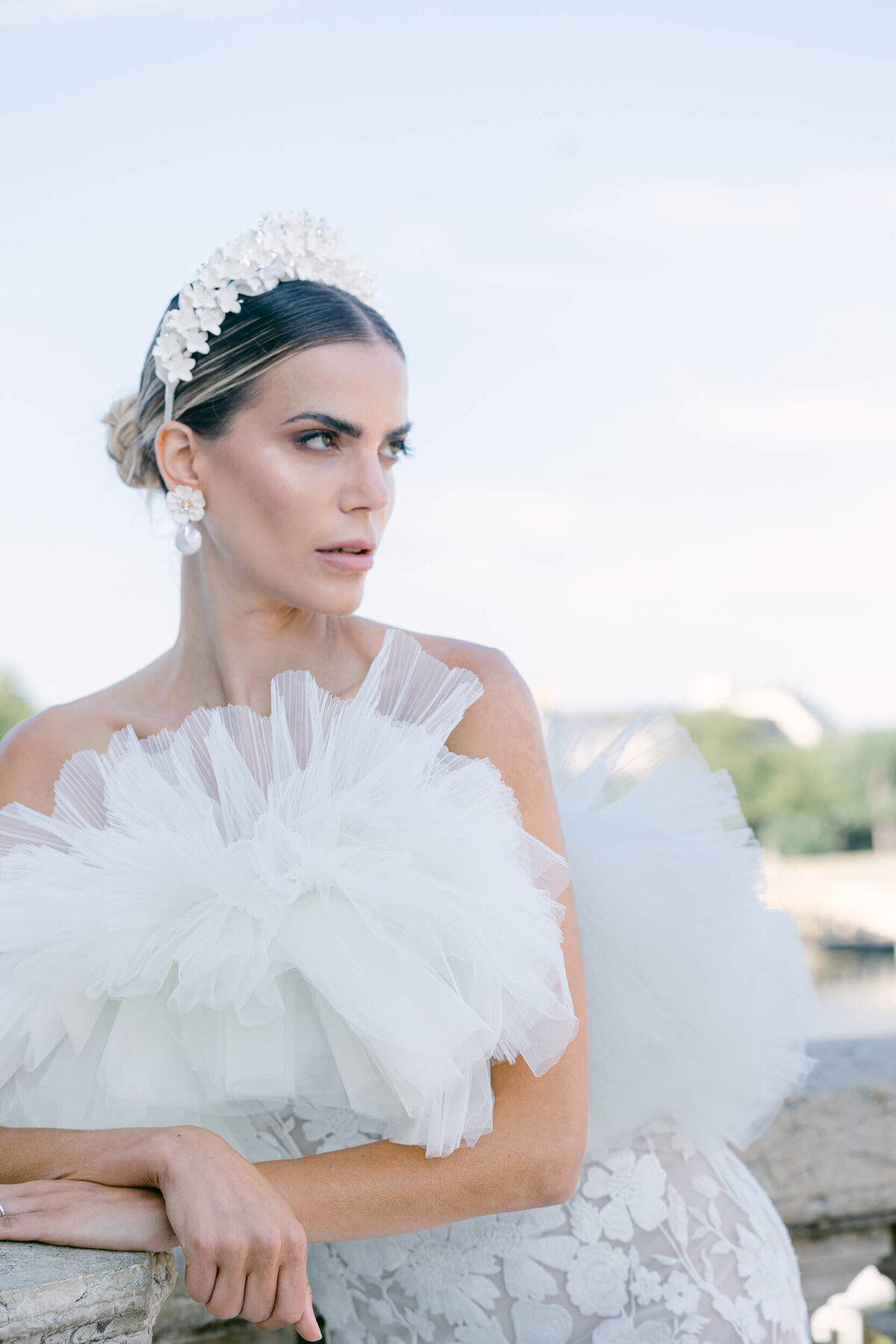 A wedding photo of a bride in her white dress in the streets of Paris in France.