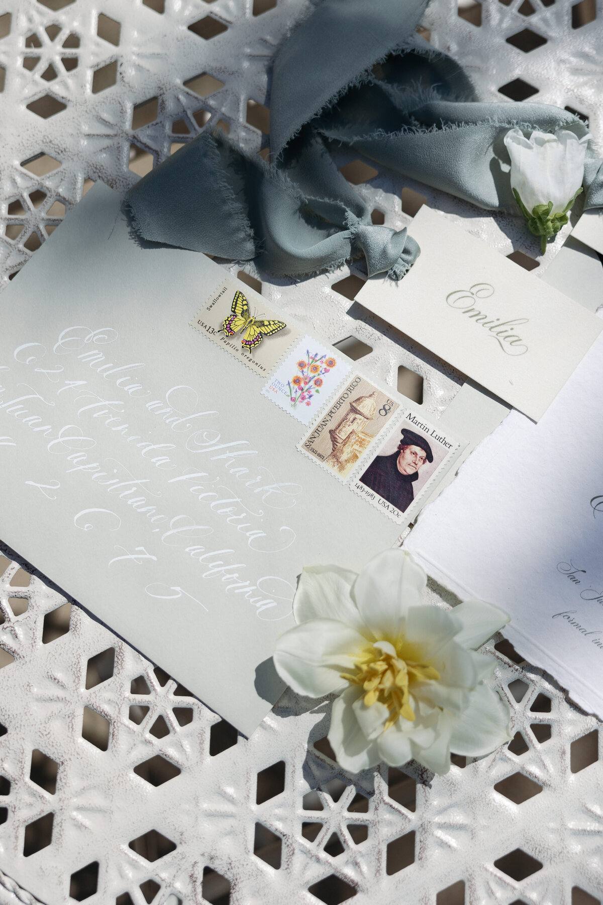 Elegant wedding invitation suite featuring floral designs, beautifully arranged on a marble table in La Jolla in Southern California.