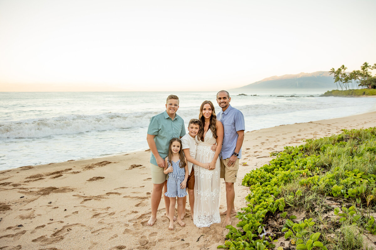 Maui Family Photographers capture family standing on beach during beach family photos