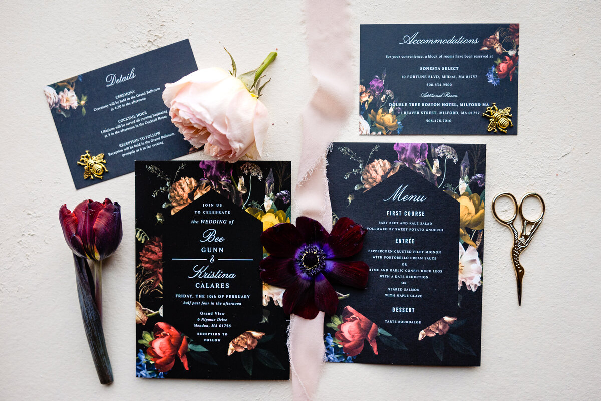 Black wedding invitations with dark flowers on them