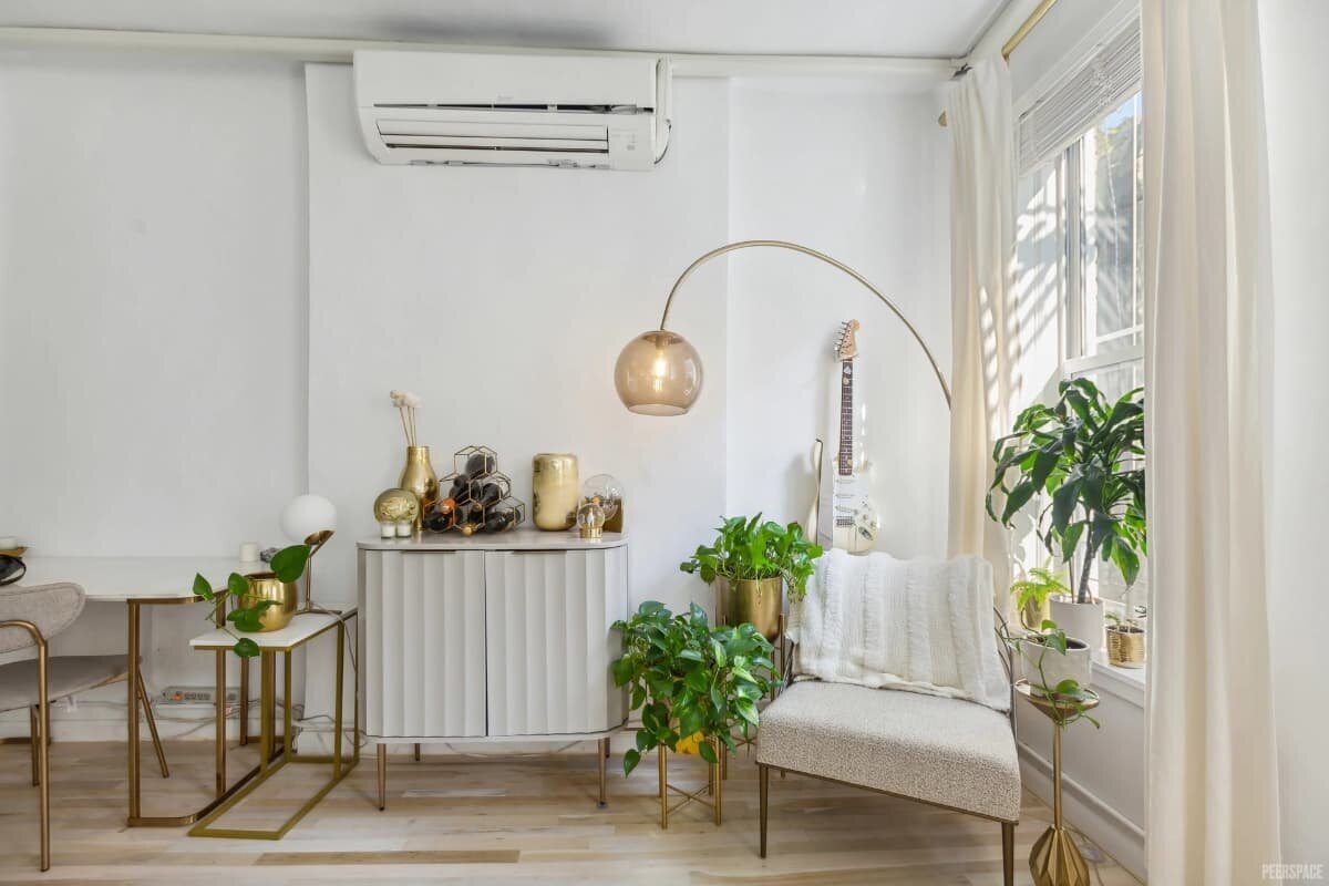 NYC brand photography studio lounge chair styled with modern lamp, plants, and natural window light.